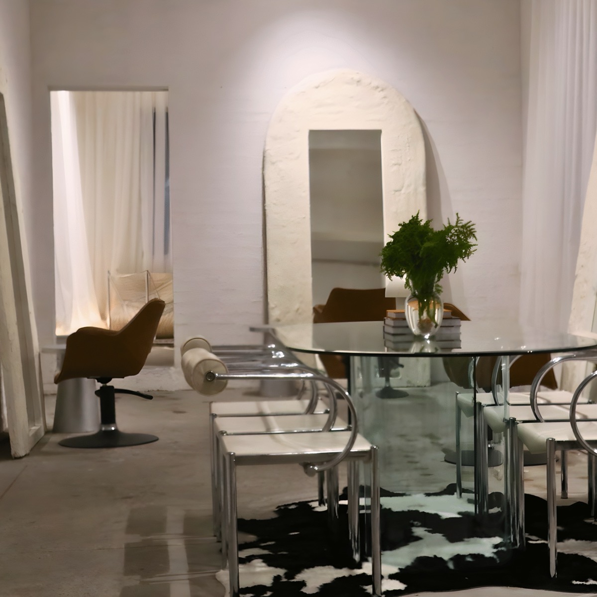 The BlondeDenm styling floor: arched mirrors, a glass table and soft daylight