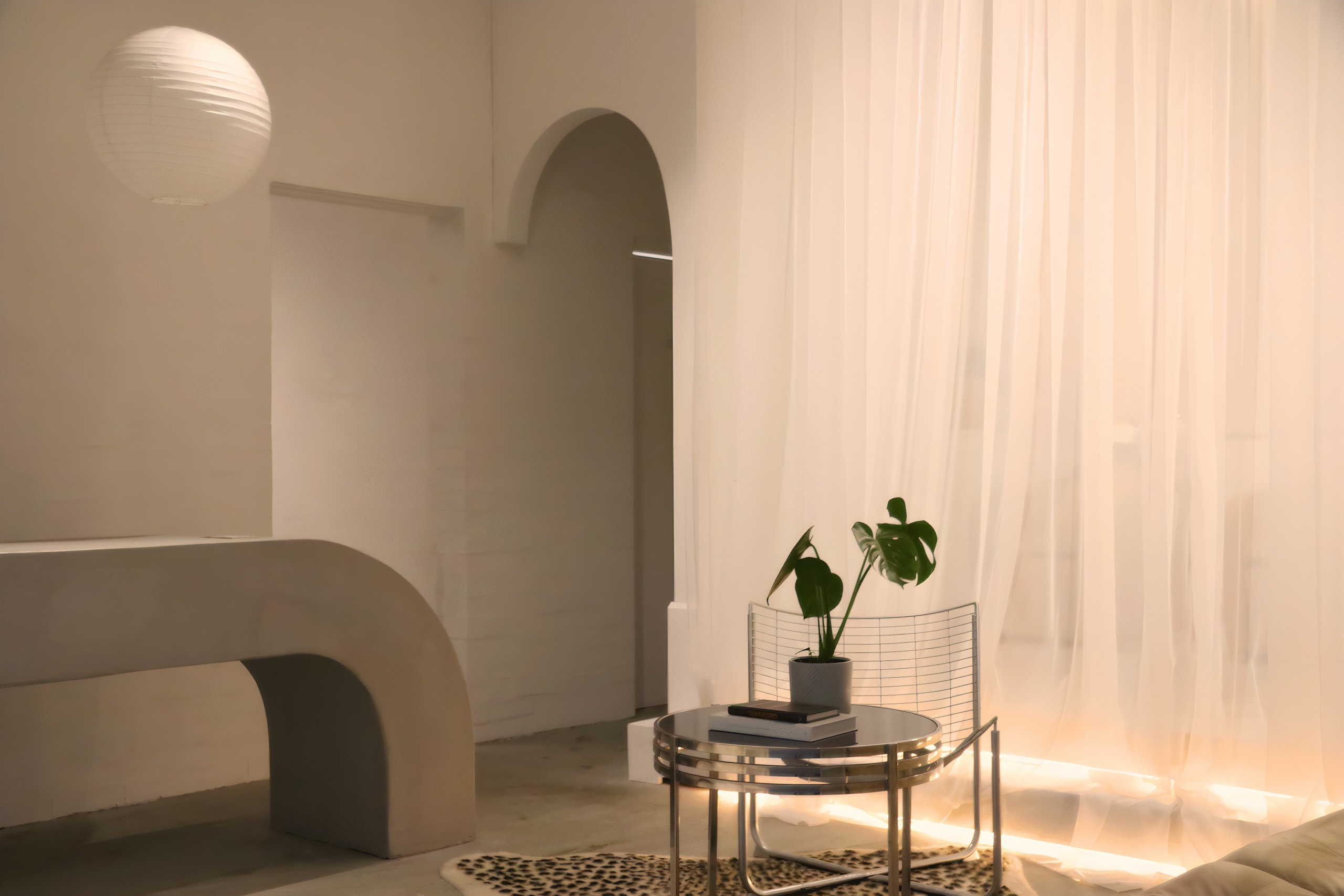 BlondeDenm’s reception: a curved white bench beneath an arched niche, sheer curtains and a small side table with a plant